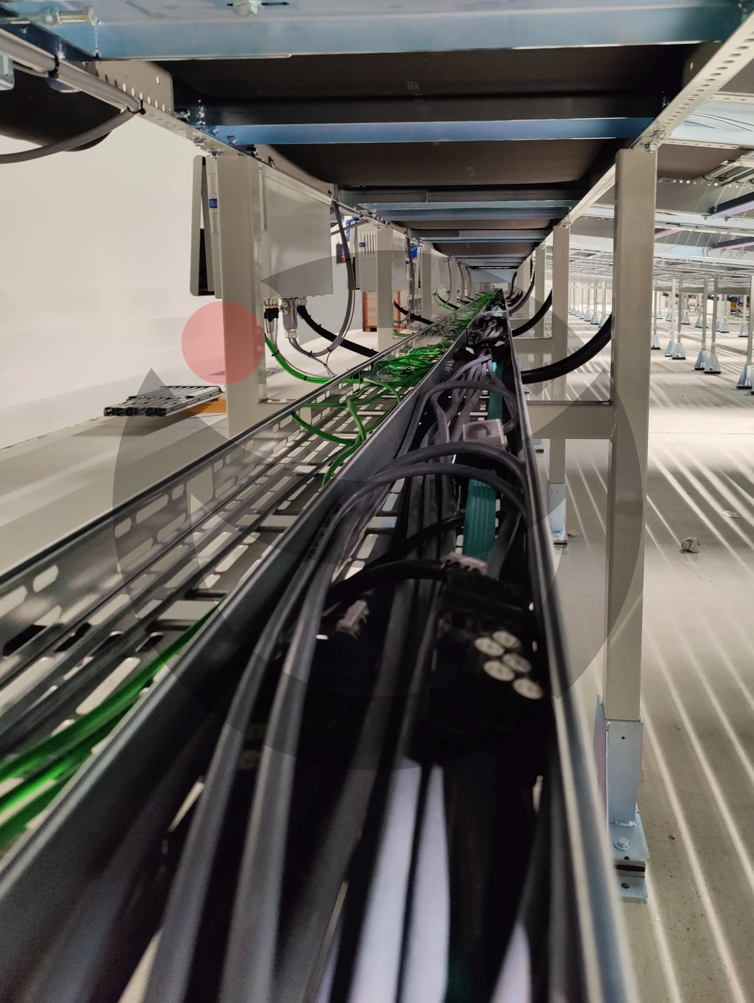 Heavy-duty steel cable trays and long-distance cable runs along conveyor line